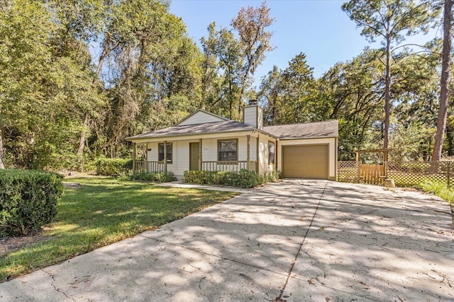 single story home with a garage, a front yard, and a porch