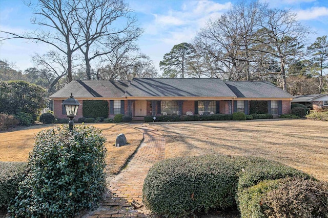 ranch-style home with a front lawn