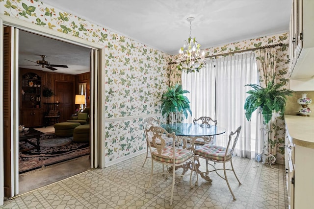 dining room featuring ceiling fan with notable chandelier