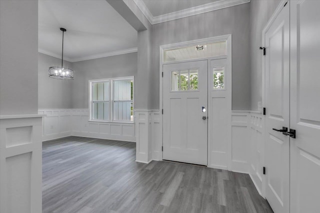 10096 Green Fountain Rd, Tallahassee, FL 32305 - foyer with a decorative wall, ornamental molding, dark wood-type flooring, wainscoting, and a chandelier