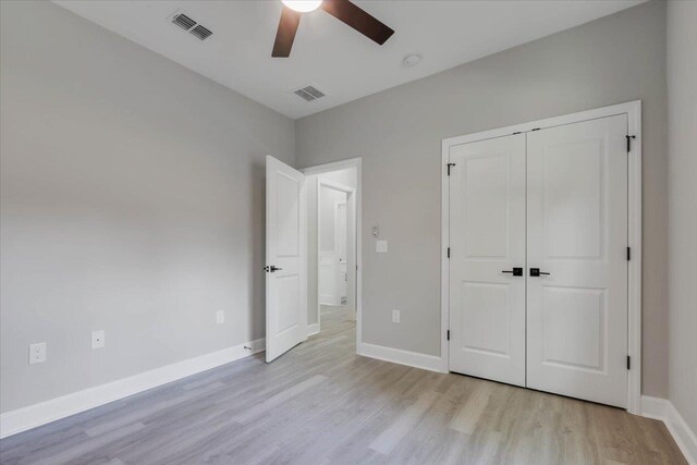 10096 Green Fountain Rd, Tallahassee, FL 32305 - unfurnished bedroom with light wood-type flooring, a closet, a ceiling fan, and baseboards
