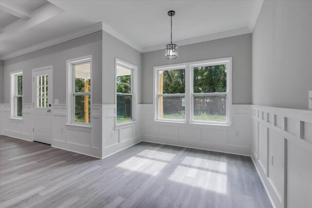 10096 Green Fountain Rd, Tallahassee, FL 32305 - unfurnished dining area with wainscoting, wood finished floors, a decorative wall, a chandelier, and ornamental molding