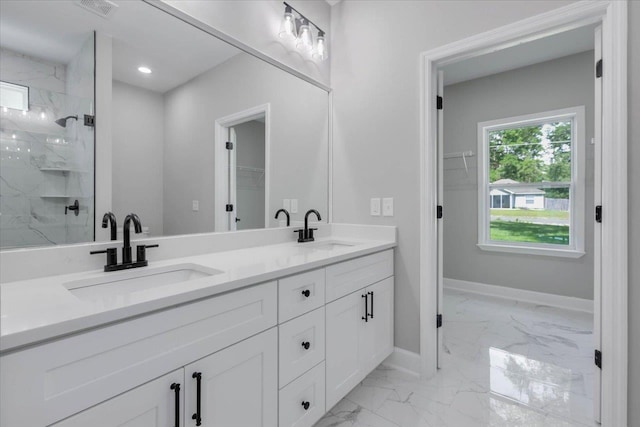 10096 Green Fountain Rd, Tallahassee, FL 32305 - full bathroom featuring marble look tiles, baseboards, a walk in closet, double vanity, and a marble finish shower