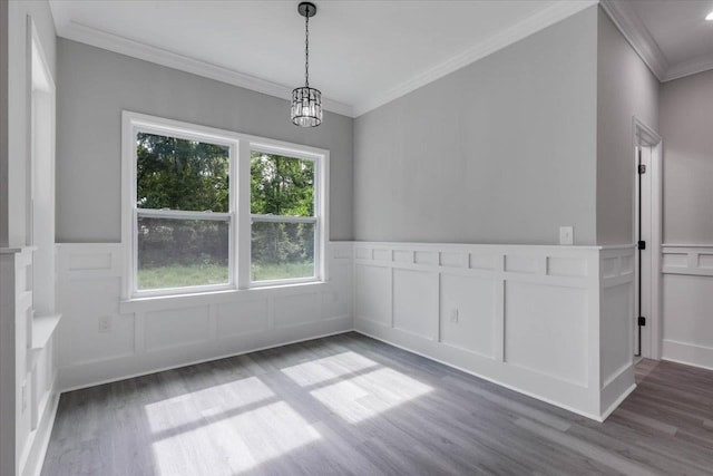 10096 Green Fountain Rd, Tallahassee, FL 32305 - unfurnished dining area with wood finished floors, crown molding, a decorative wall, wainscoting, and a chandelier
