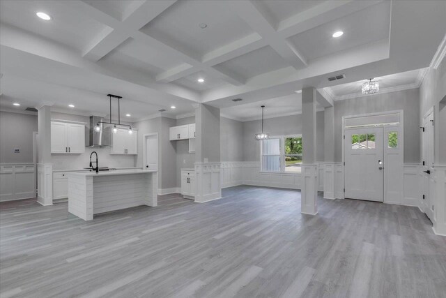 10096 Green Fountain Rd, Tallahassee, FL 32305 - unfurnished living room featuring a chandelier, coffered ceiling, a sink, light wood-style flooring, and beamed ceiling
