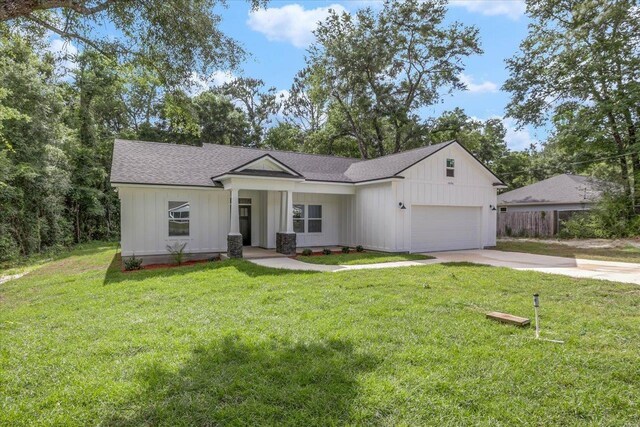 10096 Green Fountain Rd, Tallahassee, FL 32305 - view of front of home with concrete driveway, a front lawn, a garage, and roof with shingles