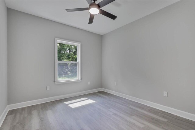 10096 Green Fountain Rd, Tallahassee, FL 32305 - spare room with wood finished floors, a ceiling fan, and baseboards