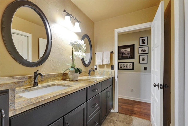 bathroom featuring double vanity, tile patterned floors, and a sink