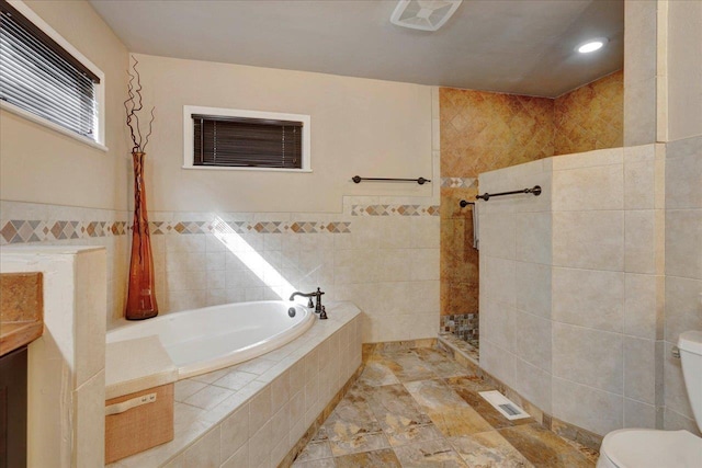 bathroom featuring a garden tub, visible vents, a tile shower, tile walls, and toilet