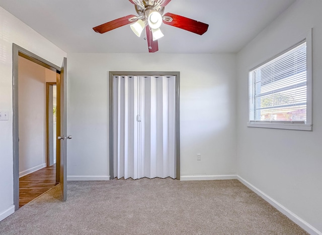 unfurnished bedroom with baseboards, carpet floors, and ceiling fan