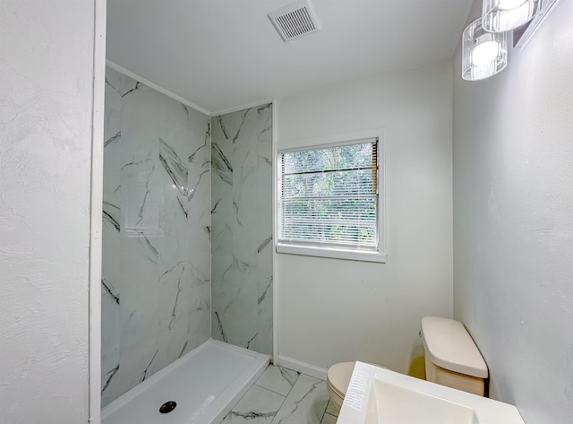 bathroom with a marble finish shower, visible vents, marble finish floor, and toilet