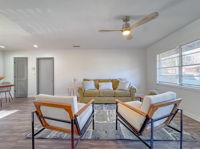 living area featuring a ceiling fan, visible vents, baseboards, recessed lighting, and dark wood-type flooring