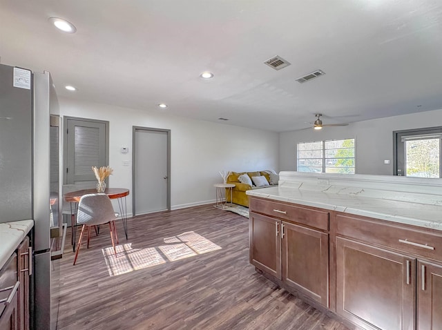 kitchen featuring visible vents, freestanding refrigerator, ceiling fan, and wood finished floors