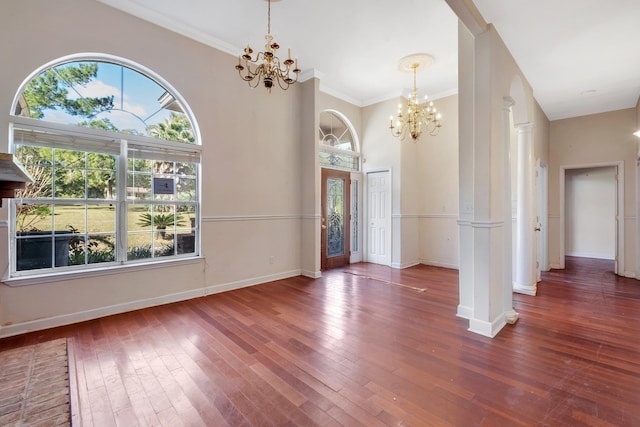 foyer with decorative columns, dark hardwood / wood-style floors, and plenty of natural light