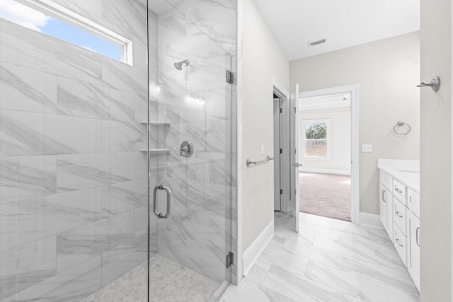 bathroom with vanity and a shower with shower door