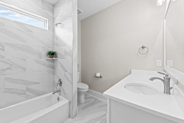 full bathroom featuring tiled shower / bath, vanity, and toilet