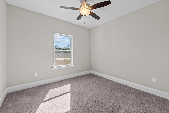 unfurnished room with ceiling fan and carpet