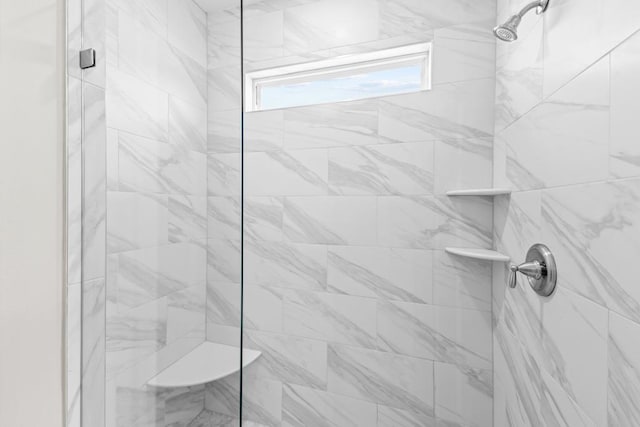 bathroom with a tile shower