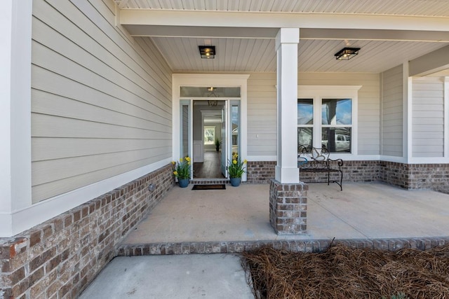 doorway to property featuring covered porch