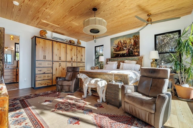 bedroom featuring a wall mounted air conditioner, wooden ceiling, hardwood / wood-style floors, and ensuite bath