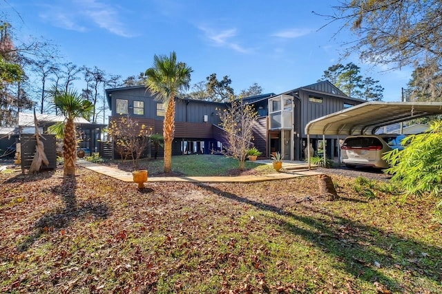 back of property featuring a yard and a carport