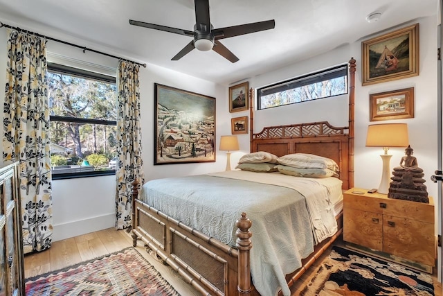 bedroom with ceiling fan and wood-type flooring