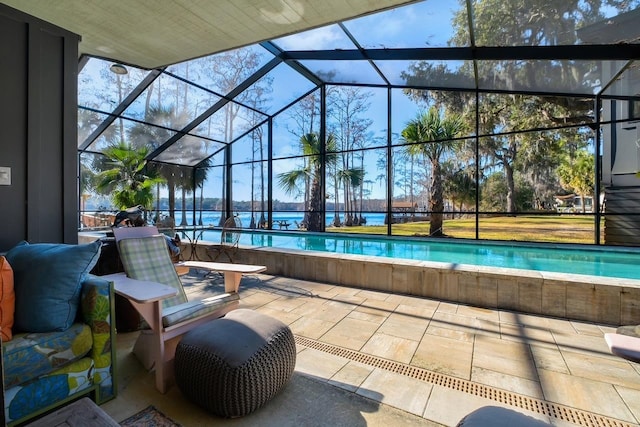 view of swimming pool featuring a patio, a water view, and a lanai