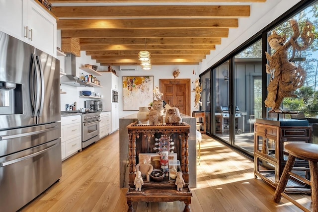 kitchen featuring beam ceiling, stainless steel appliances, island exhaust hood, light hardwood / wood-style floors, and white cabinets