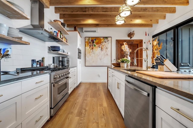 kitchen featuring ventilation hood, sink, appliances with stainless steel finishes, beamed ceiling, and white cabinetry