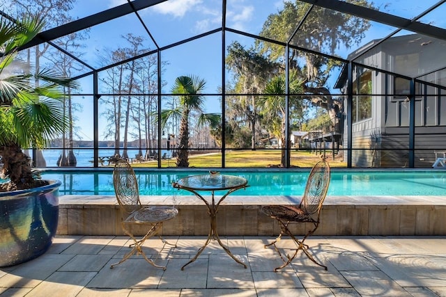 view of pool with a lanai and a water view