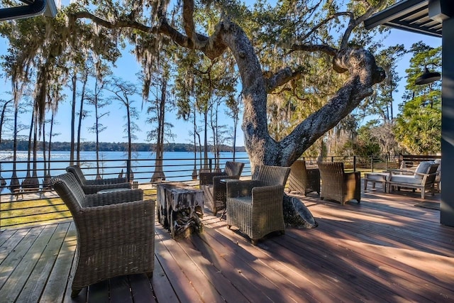 wooden terrace featuring a water view