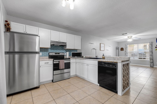 1903 Larette Dr, Tallahassee, FL 32301 - kitchen featuring stainless steel appliances, a sink, under cabinet range hood, a peninsula, and a textured ceiling