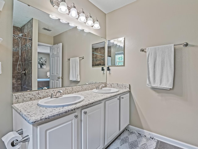 7214 Jaffrey Ct, Tallahassee, FL 32312 - full bathroom featuring double vanity, tiled shower, tile patterned floors, and baseboards