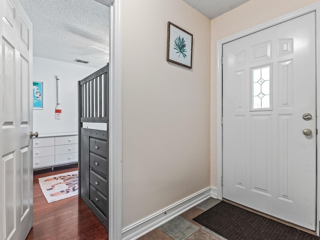 7214 Jaffrey Ct, Tallahassee, FL 32312 - entryway with a textured ceiling, dark wood-style floors, and baseboards