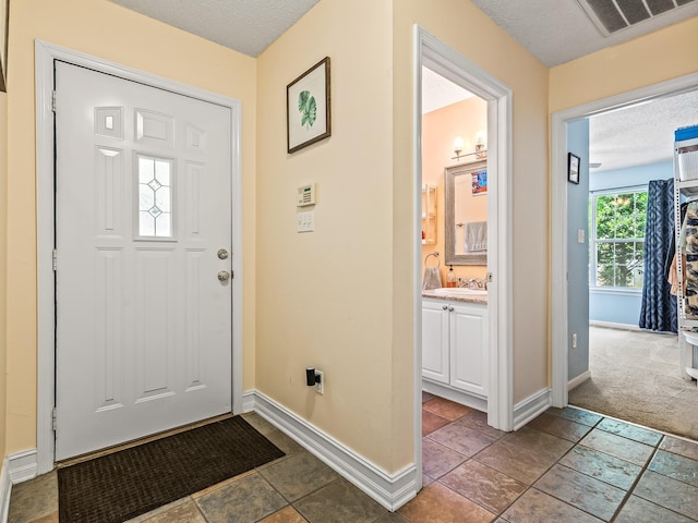7214 Jaffrey Ct, Tallahassee, FL 32312 - foyer with baseboards and a textured ceiling