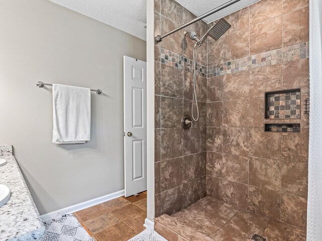 7214 Jaffrey Ct, Tallahassee, FL 32312 - full bath featuring a textured ceiling, a tile shower, baseboards, and vanity