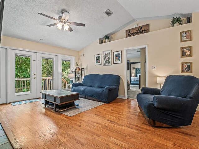 7214 Jaffrey Ct, Tallahassee, FL 32312 - living area featuring vaulted ceiling, ceiling fan, light wood-style flooring, and a textured ceiling