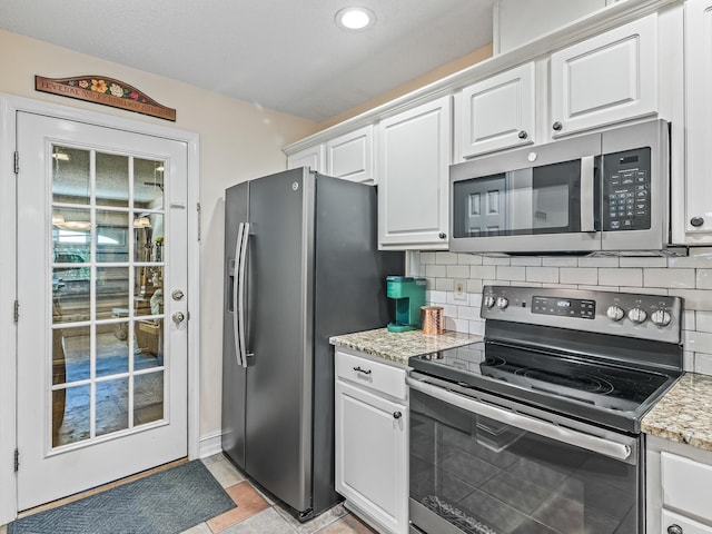 7214 Jaffrey Ct, Tallahassee, FL 32312 - kitchen featuring stainless steel appliances, white cabinetry, tasteful backsplash, light stone countertops, and recessed lighting