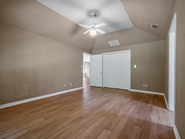 unfurnished bedroom with baseboards, wood finished floors, and visible vents