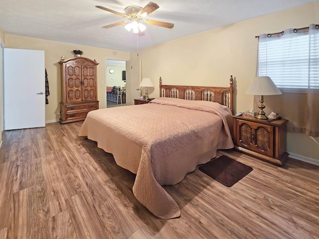 bedroom featuring wood-type flooring and ceiling fan