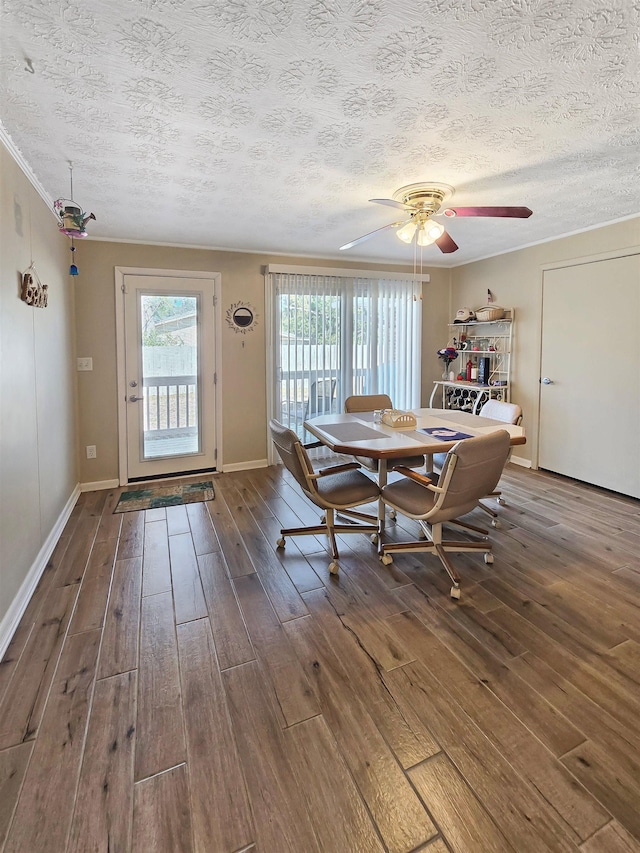 unfurnished dining area with hardwood / wood-style flooring, ceiling fan, crown molding, and a textured ceiling