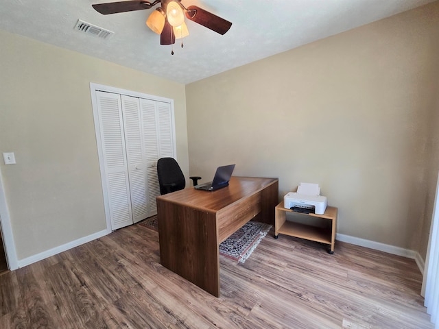 office space featuring ceiling fan, a textured ceiling, and light wood-type flooring