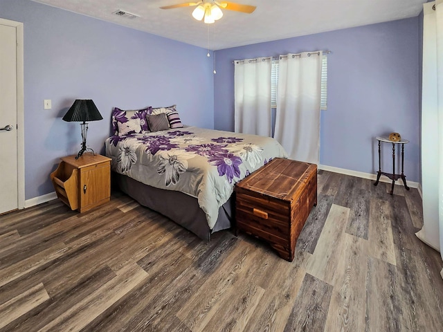 bedroom with dark hardwood / wood-style floors and ceiling fan