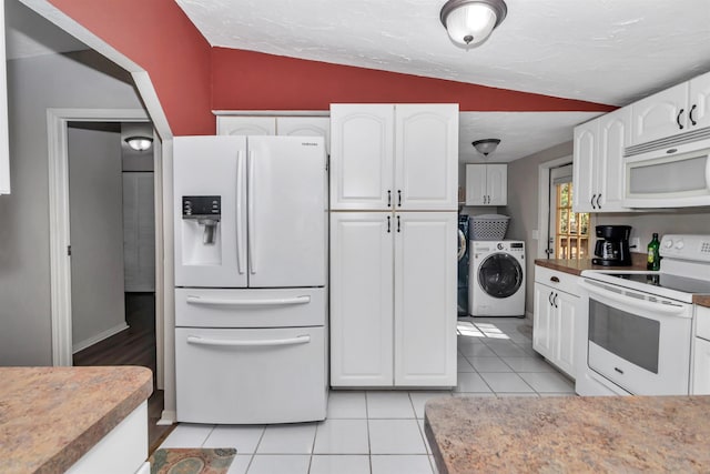 kitchen featuring washer / clothes dryer, white appliances, white cabinetry, and vaulted ceiling