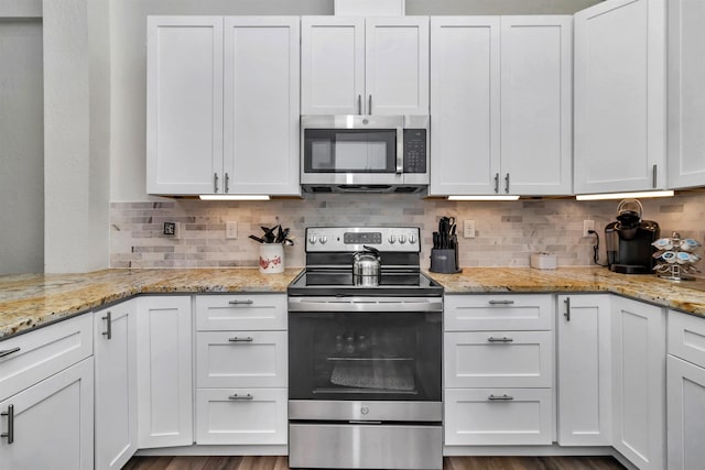 kitchen with stainless steel appliances and white cabinetry