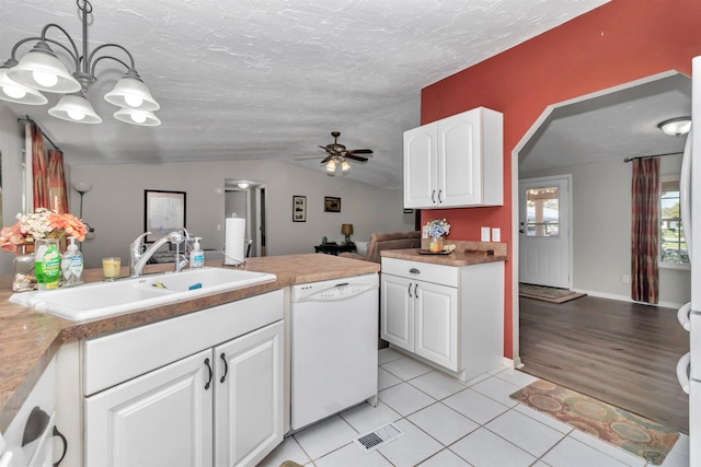 kitchen featuring hanging light fixtures, a sink, white cabinetry, and dishwasher