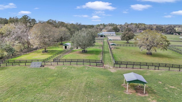 surrounding community featuring a rural view, a yard, and fence