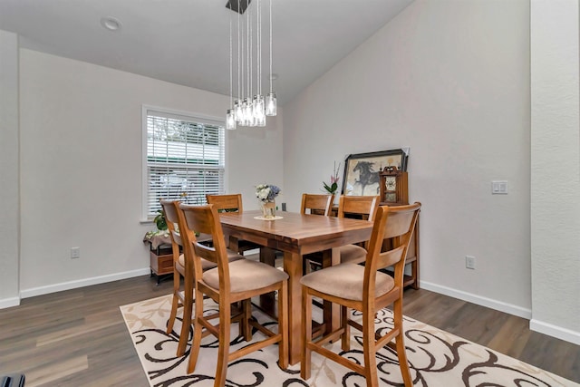 dining room with dark wood-type flooring and baseboards