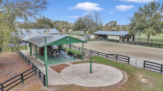 view of community with a rural view and an enclosed area