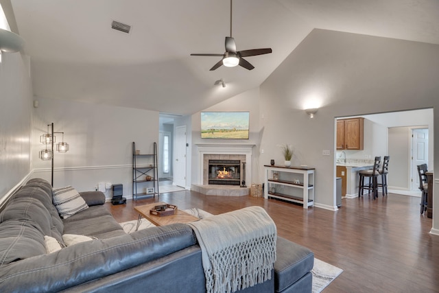 1989 Setting Sun Trl, Tallahassee, FL 32303 - living area featuring ceiling fan, a fireplace, dark wood-type flooring, and high vaulted ceiling